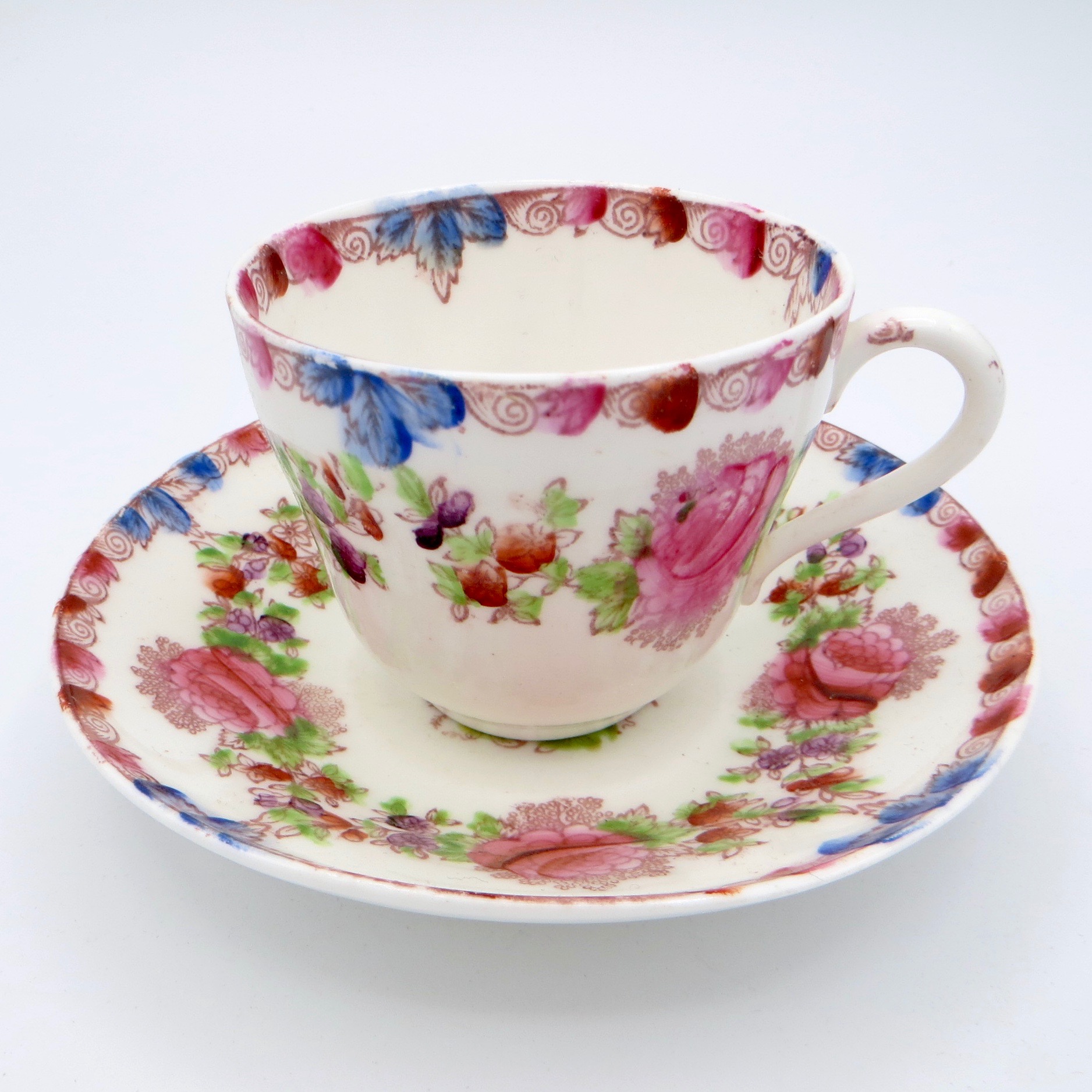 a colourful cup and saucer