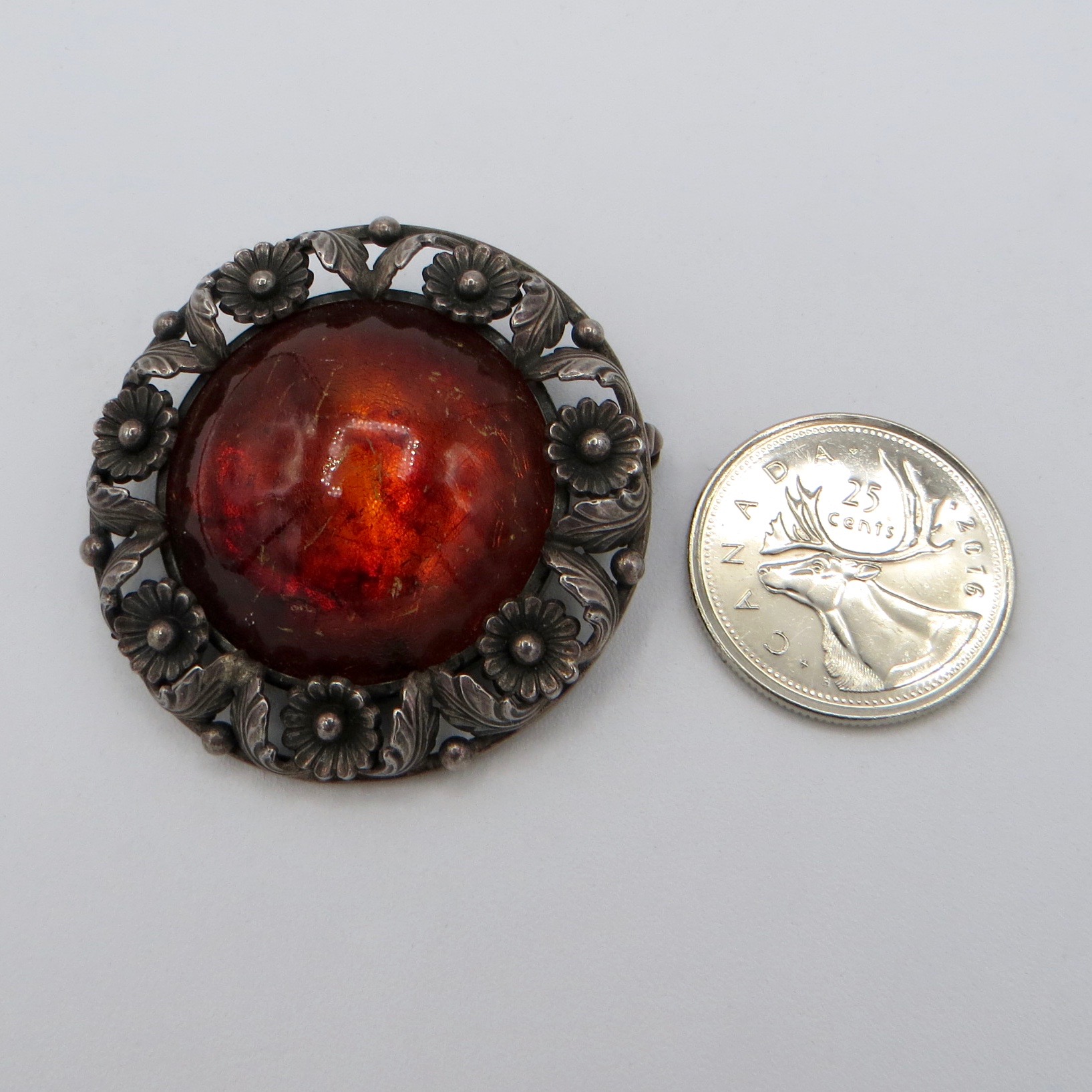 N. E. From Amber Brooch